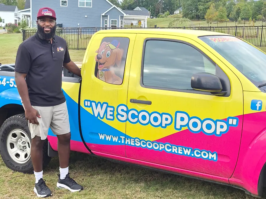 A Scoop Crew team member standing beside the branded truck